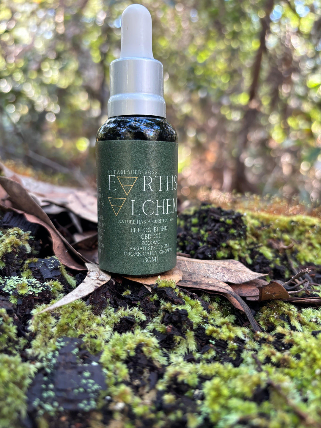 Earth’s Alchemy botanical extract oil styled with calming botanicals for ritual