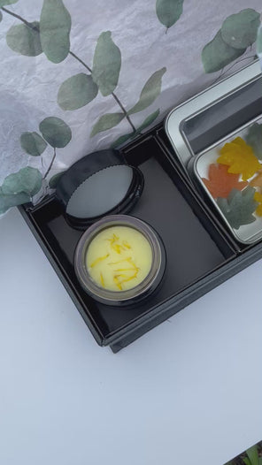Botanical Sacred Ritual Balm styled with wildflowers for self-care ritual